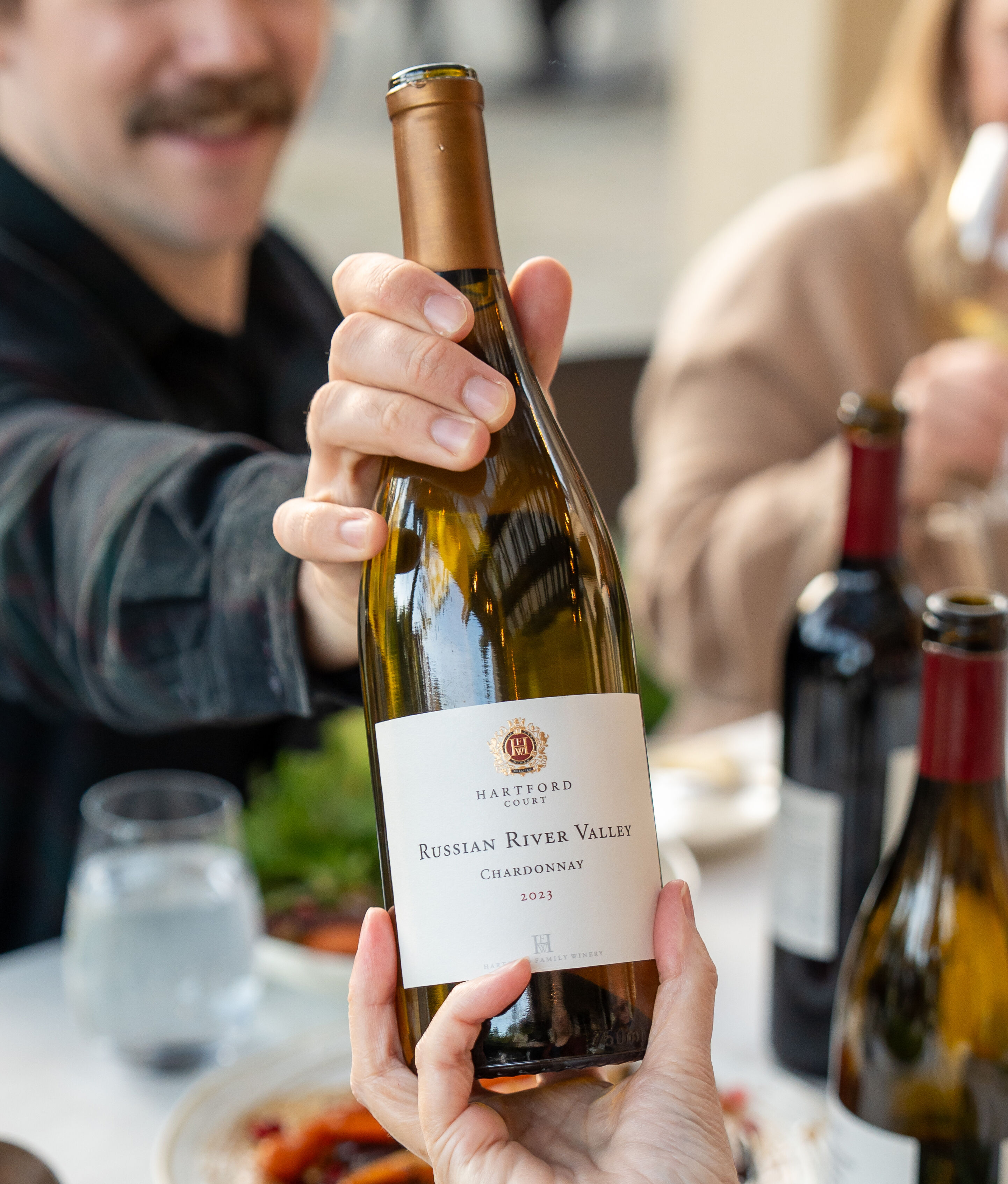MacLean holding a bottle of Hartford Chardonnay